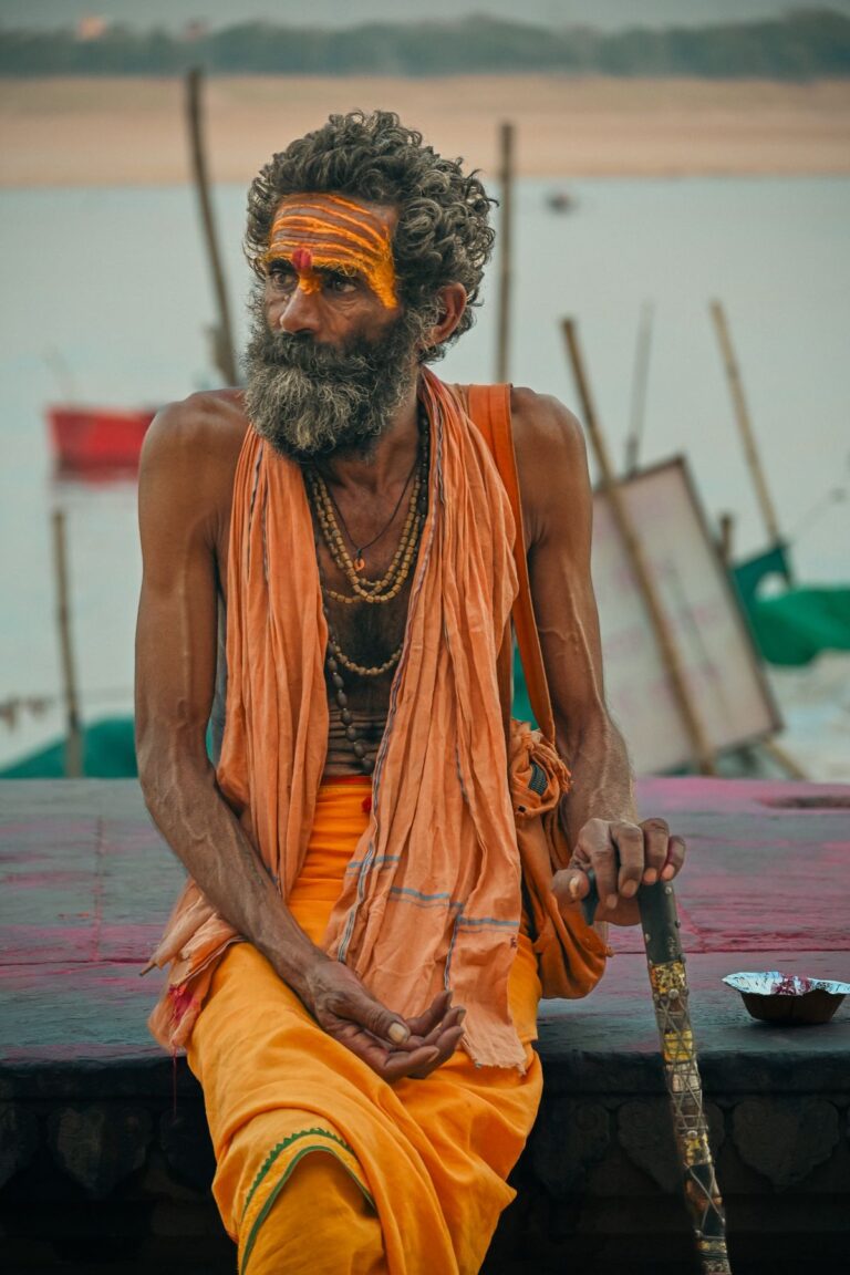 Indian sadhu seated beside the Ganges River in Varanasi