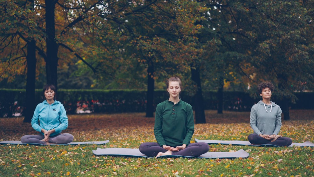 Yoga instructor guiding outdoor yoga practice for wellbeing
