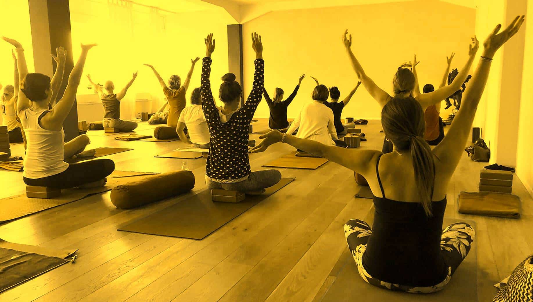 Group practising standing yoga postures during a class
