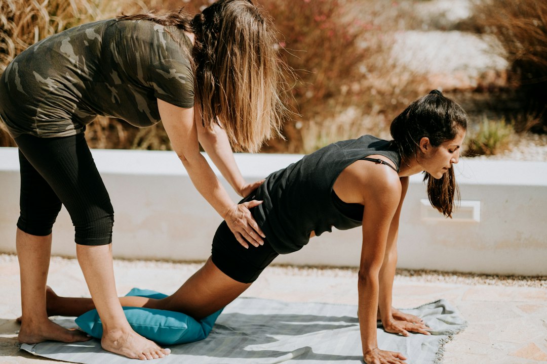 Two adults practising partner strength exercises