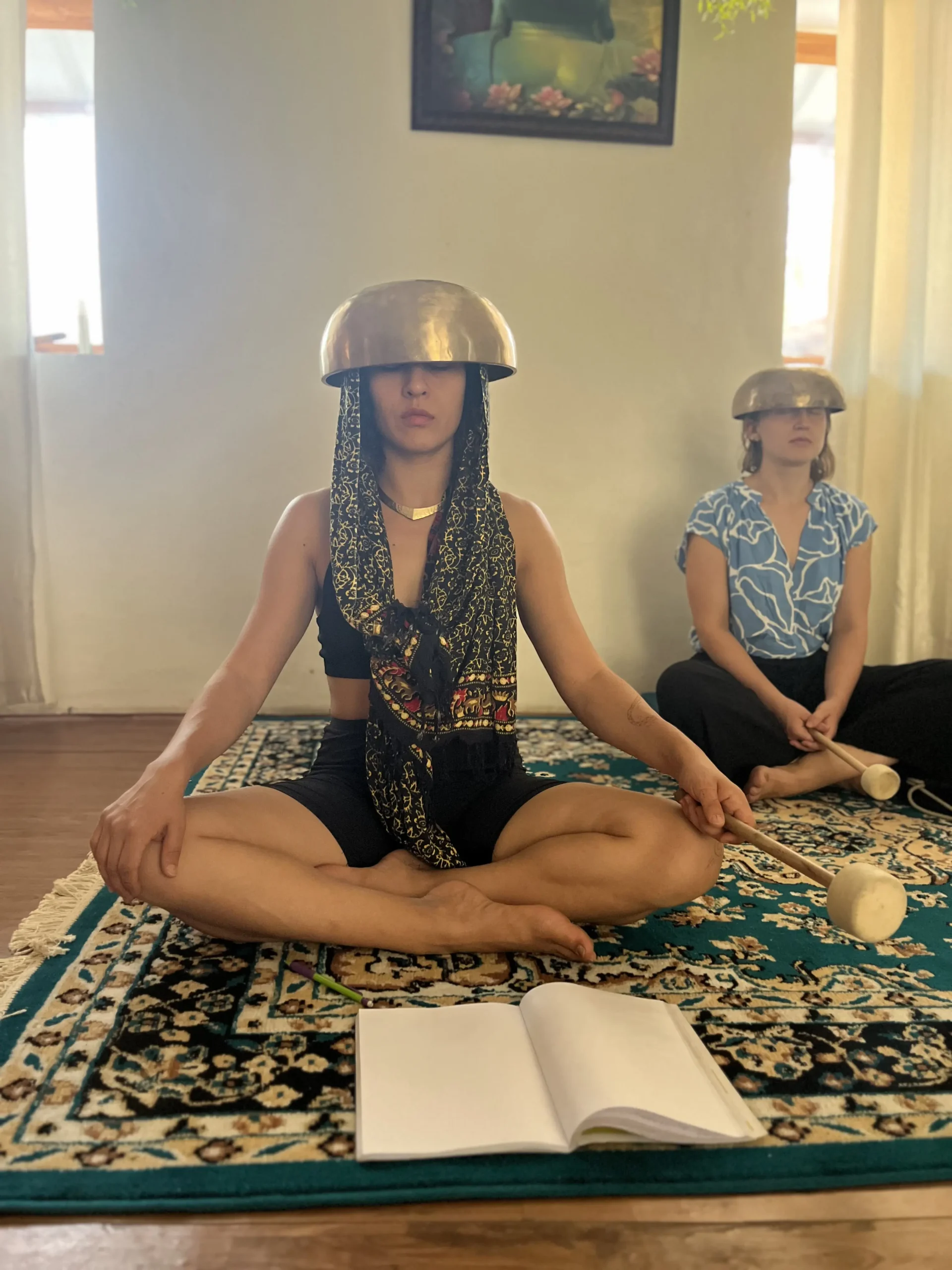 Sound healing students practicing with Himalayan singing bowls during training