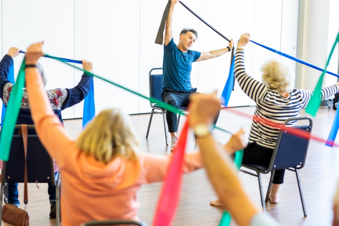 Older adults taking part in a seated chair yoga class