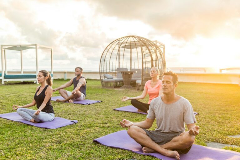 People participating in a morning yoga class as an example of a training day