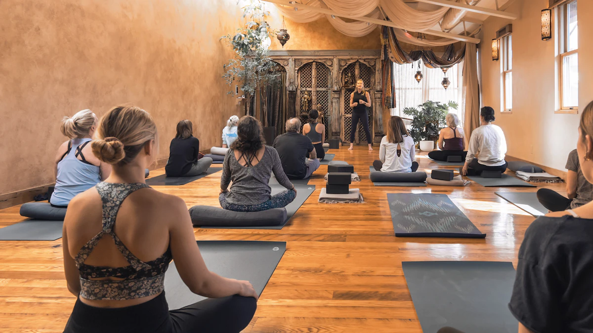 Yoga teacher training students practising teaching skills in a real class setting