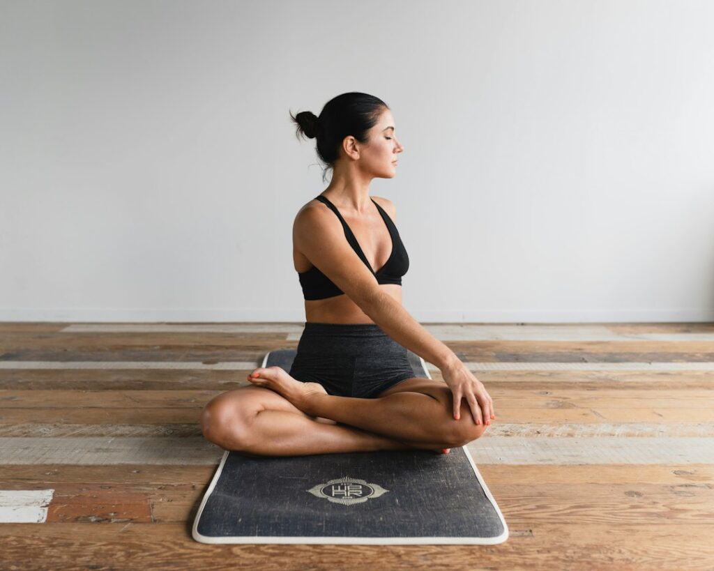 Person doing yoga in a seated posture; illustrative image, not a FitFortunes student
