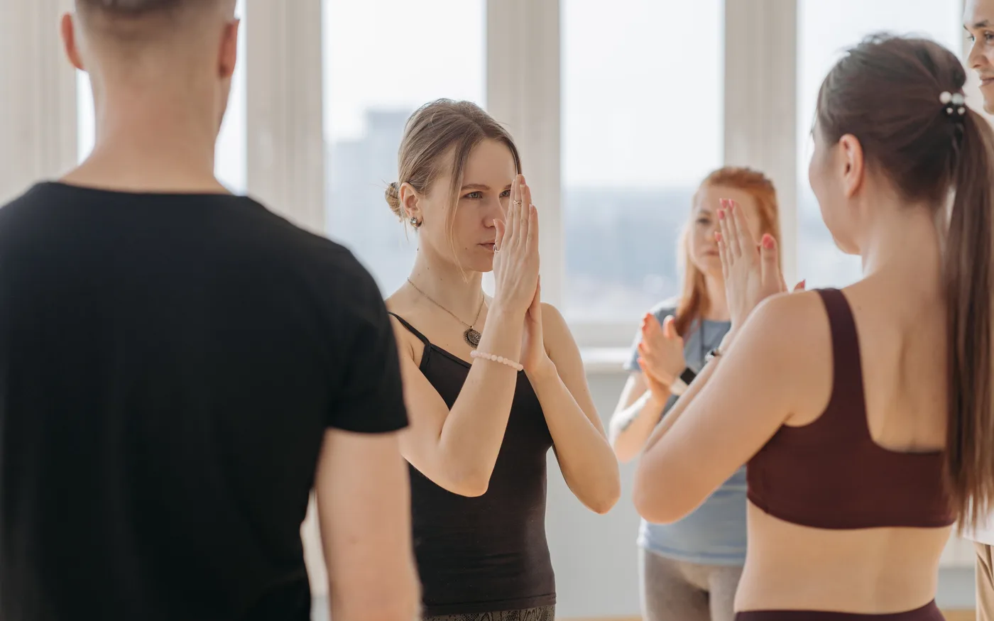 Small group practicing yoga together in a bright indoor studio