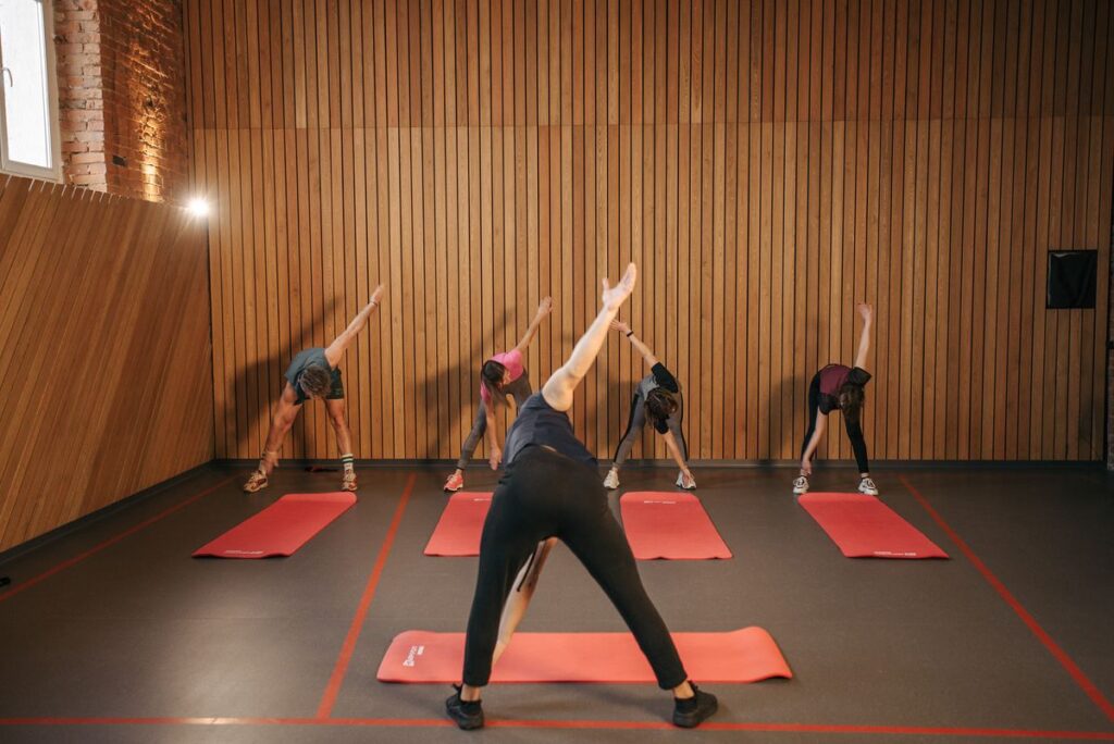 Group practising a strong flowing yoga sequence in a studio