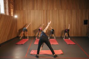 Group practising a strong flowing yoga sequence in a studio